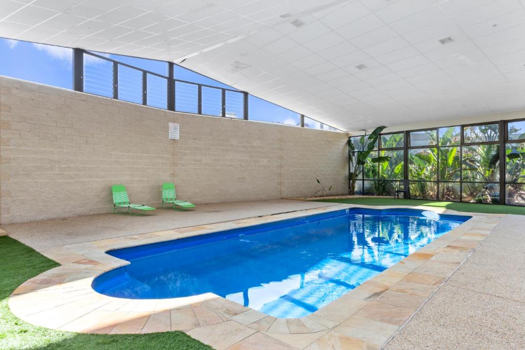 a swimming pool in a house with a building at Quality Hotel Point Cook in Point Cook