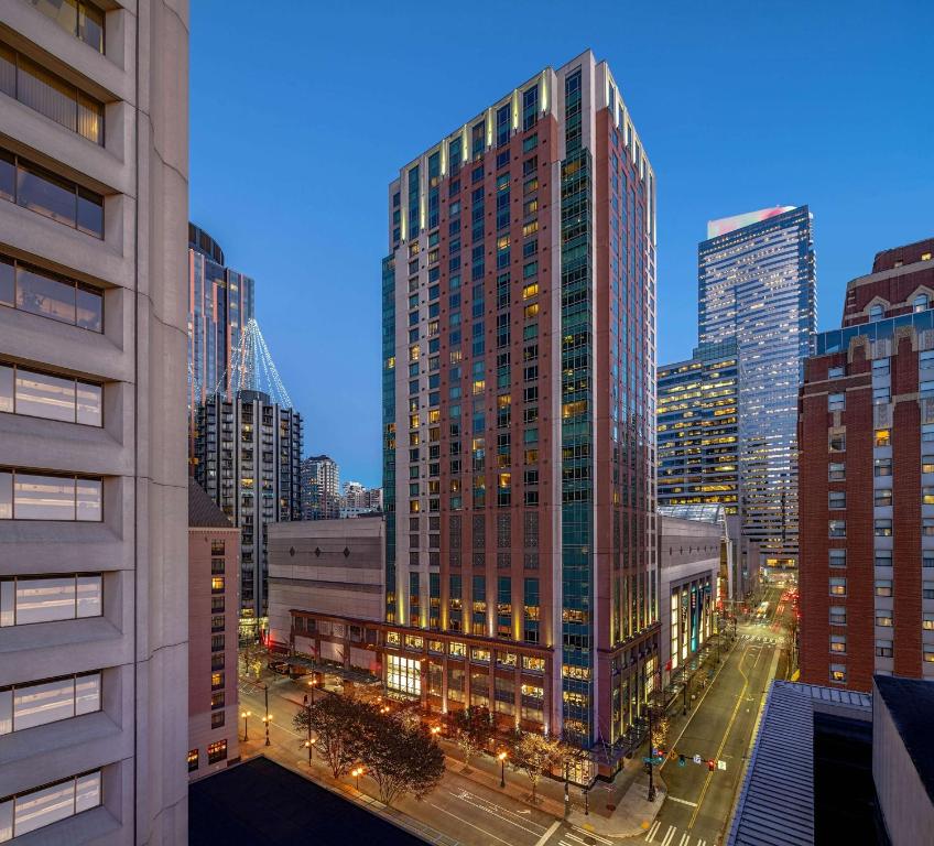 a large building with many windows in a city at Grand Hyatt Seattle in Seattle