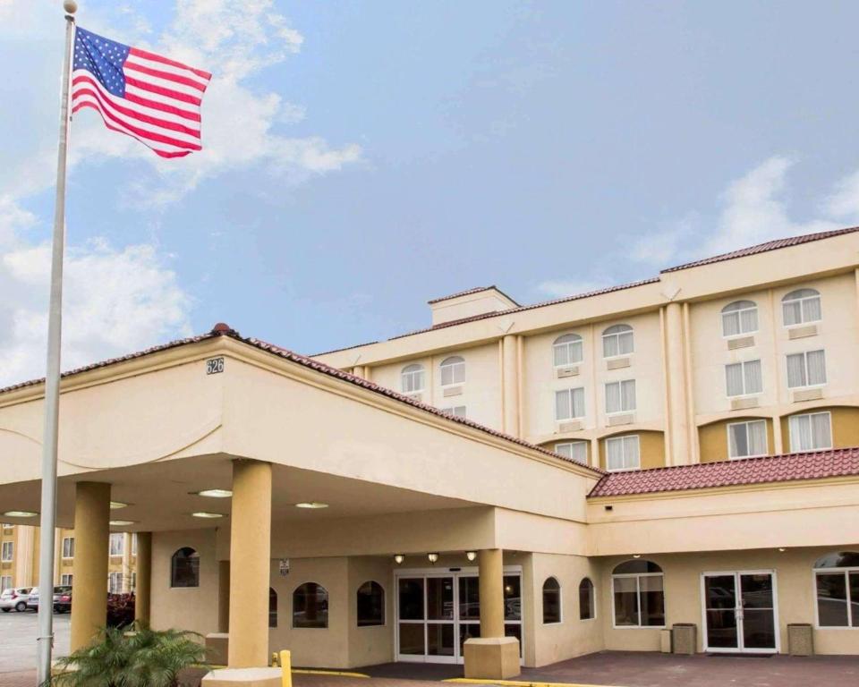 a flag flying in front of a hotel at Quality Inn & Suites Winter Park Village Area in Orlando