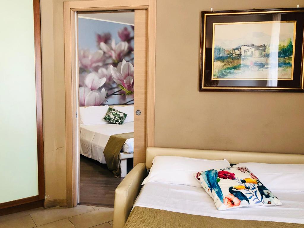 Postel nebo postele na pokoji v ubytování Hotel Acquadolce