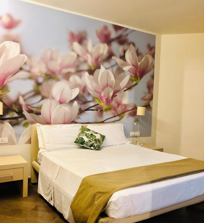 Postel nebo postele na pokoji v ubytování Hotel Acquadolce