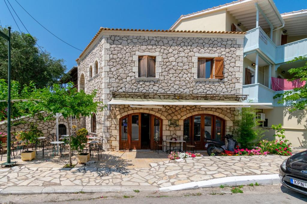 una grande casa in pietra con un patio di fronte di Averto a Città di Lefkada