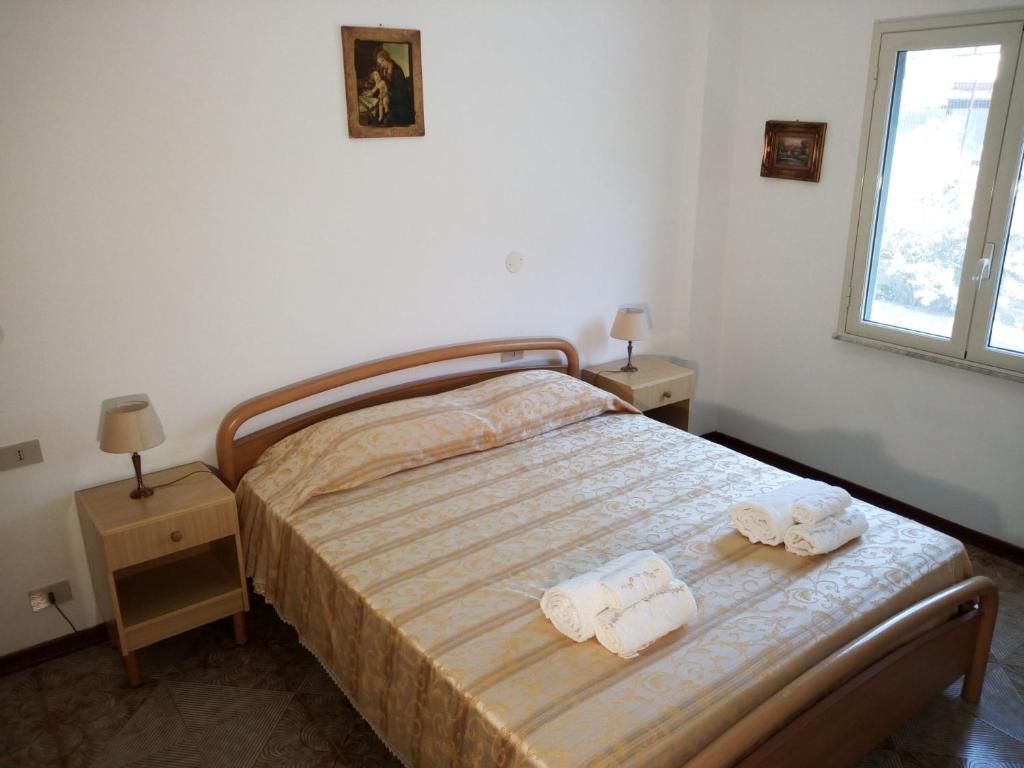 イーゾラ・デッレ・フェンミネにあるCasa Kateのベッドルーム1室(ベッド1台、タオル2枚付)