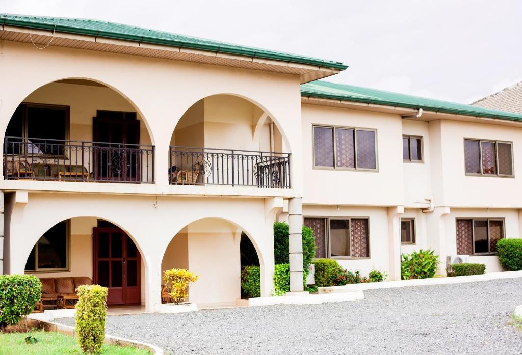 a building with arches and balconies on it at Charis Home Services in Accra