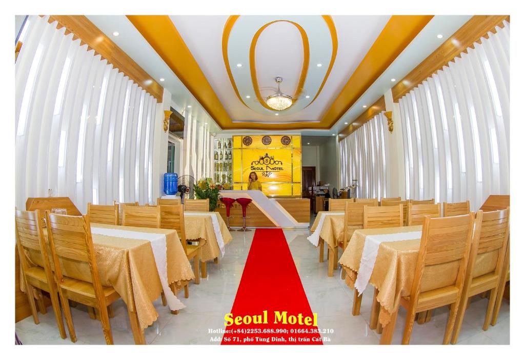 a restaurant with tables and chairs with a red carpet at Seoul Motel Seaview in Cat Ba