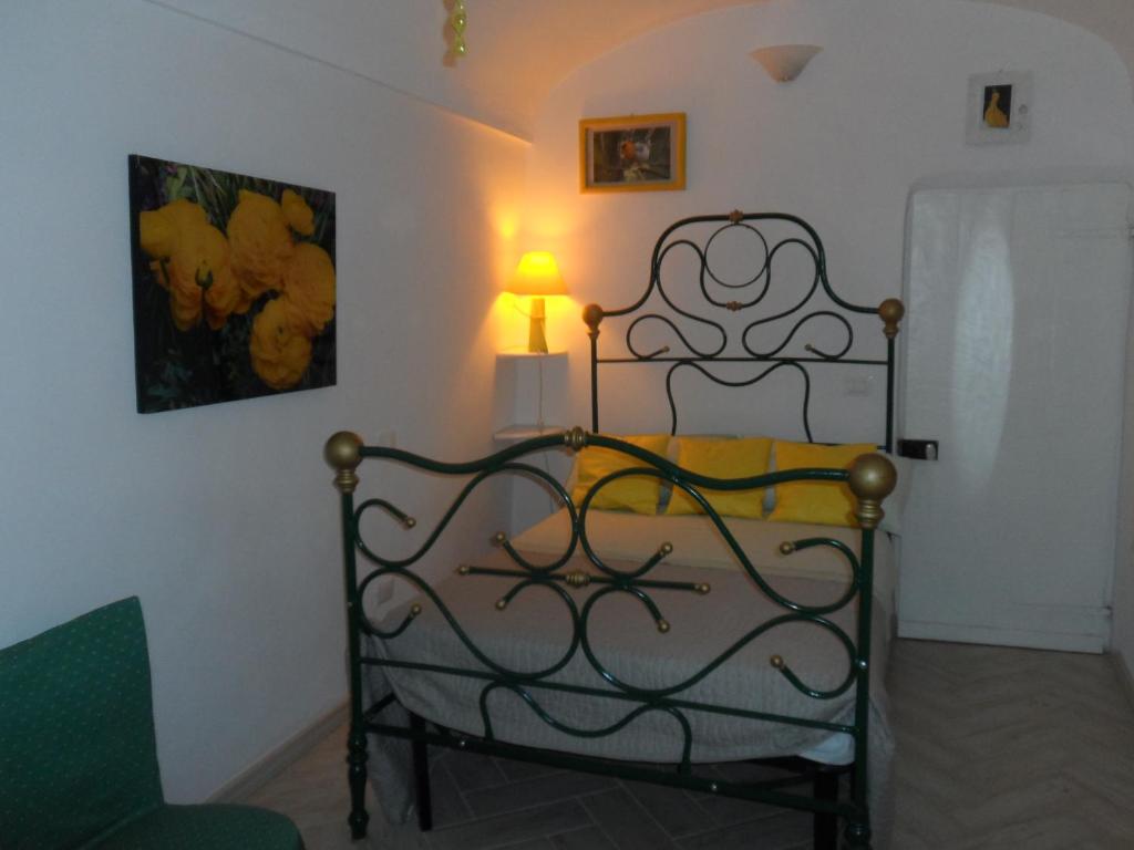 a bedroom with a bed with a lamp and a lampost at B&B Palazzo Barli in Pieve di Teco