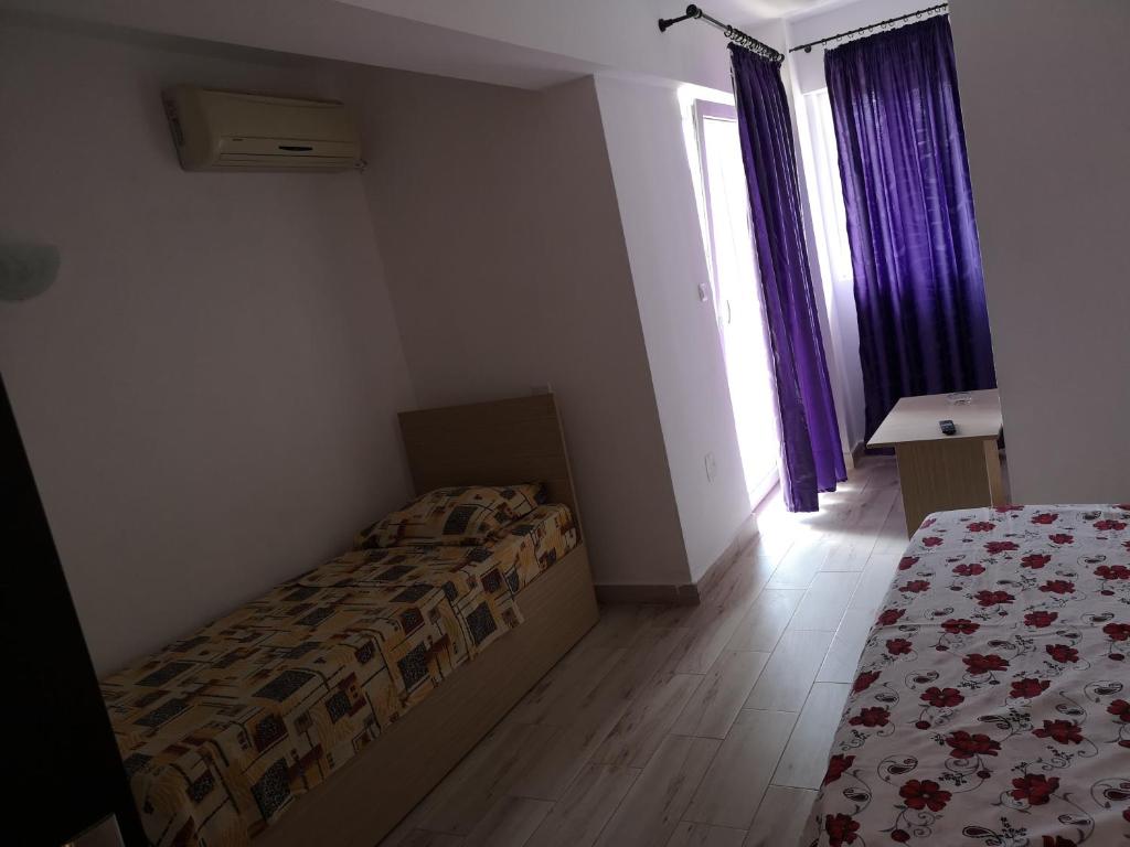 Postel nebo postele na pokoji v ubytování Vila Axel