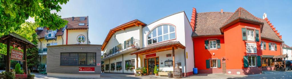 a row of colorful buildings on a street at Hotel-Restaurant zum Ochsen in Schallstadt