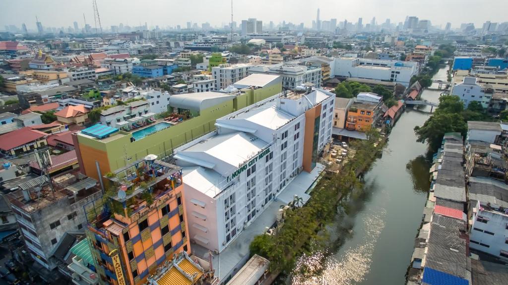an overhead view of a city with a river and buildings at Nouvo City Hotel in Bangkok