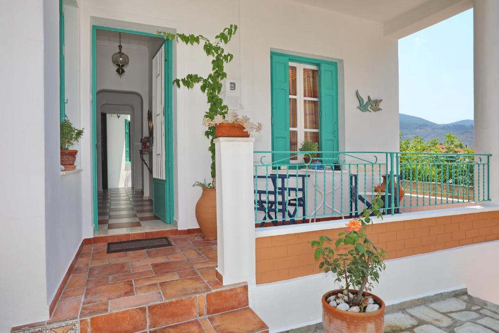 a view of a house with a balcony at Spring Bliss Garden House in Skopelos Town