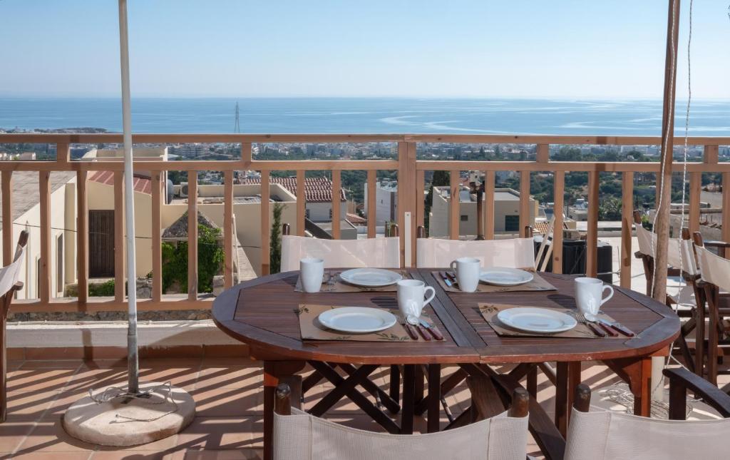 a table on a balcony with a view of the ocean at Amazones Kalimera Village in Hersonissos