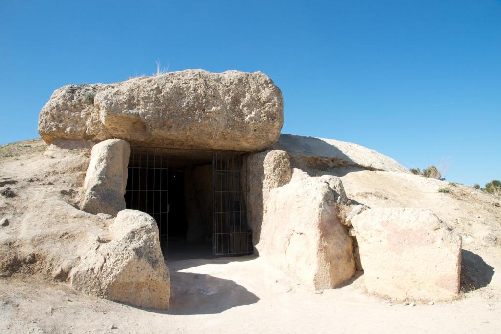 a cave in the middle of a rock at Los Dólmenes in Antequera