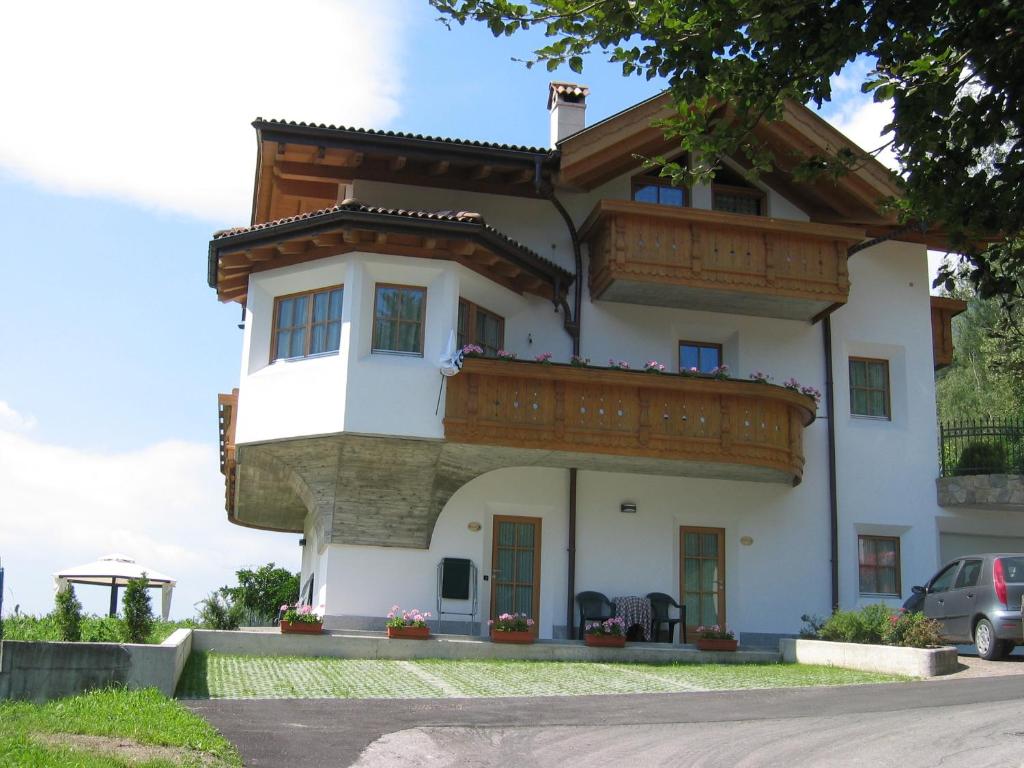 a large white house with a balcony at B&B Rendena Chalet in Strembo