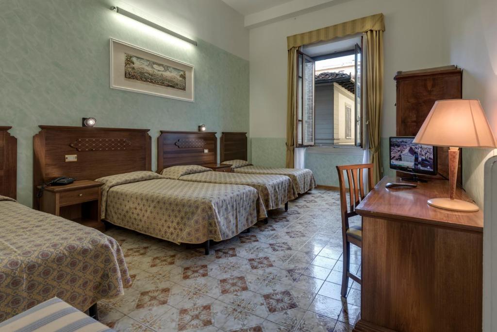 Cama o camas de una habitación en Hotel Olimpia
