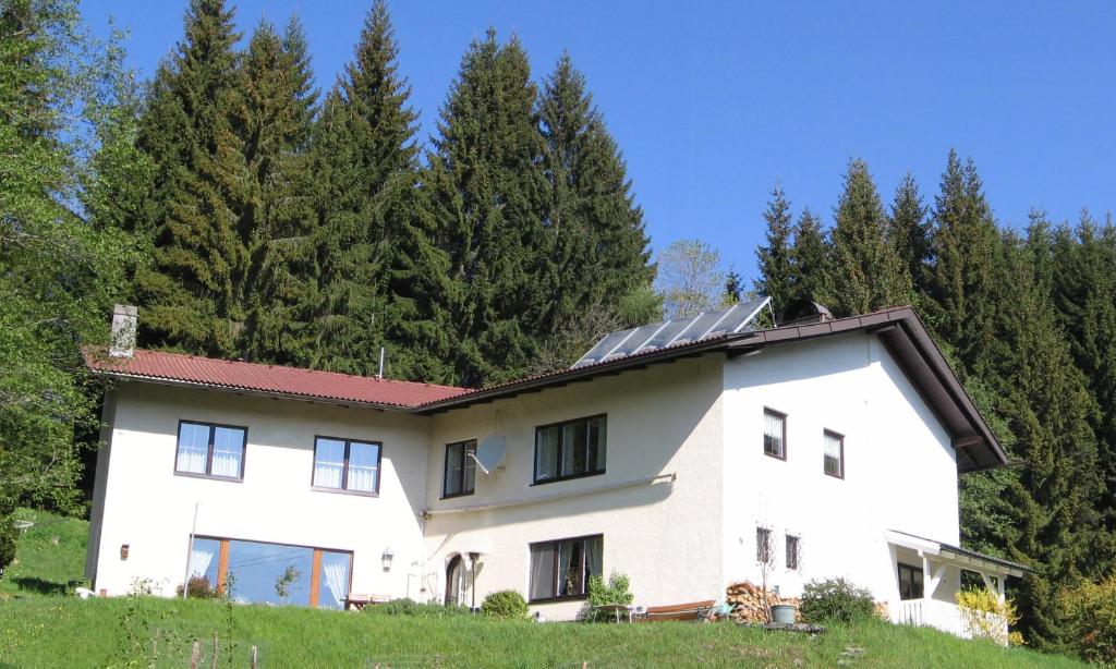 a white house with solar panels on the roof at Ferienhaus Hollinger in Afritz