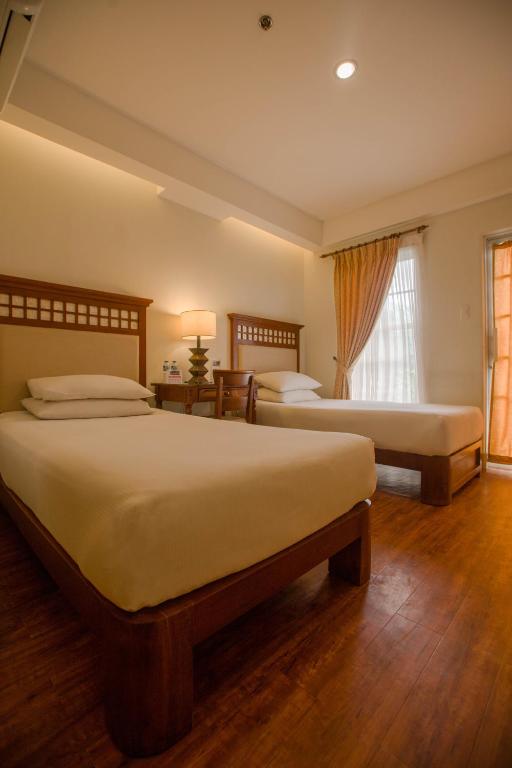 Postel nebo postele na pokoji v ubytování Hotel Emilia