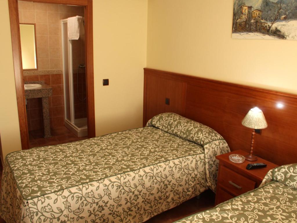 Postel nebo postele na pokoji v ubytování Nuevo Hostal Paulino