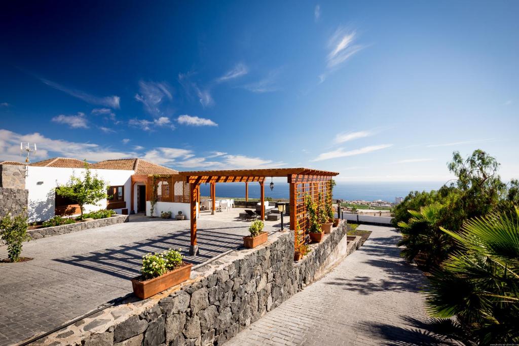 a view of a building with a stone wall at Villa Las Rosas, Los Menores, Adeje, sea view in Armeñime