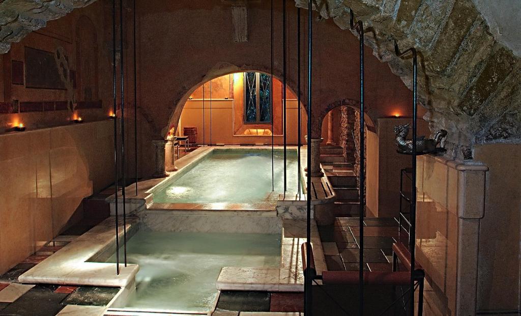 a swimming pool in a building with an archway at Residenze Gregoriane - Residenza d'Epoca in Tivoli