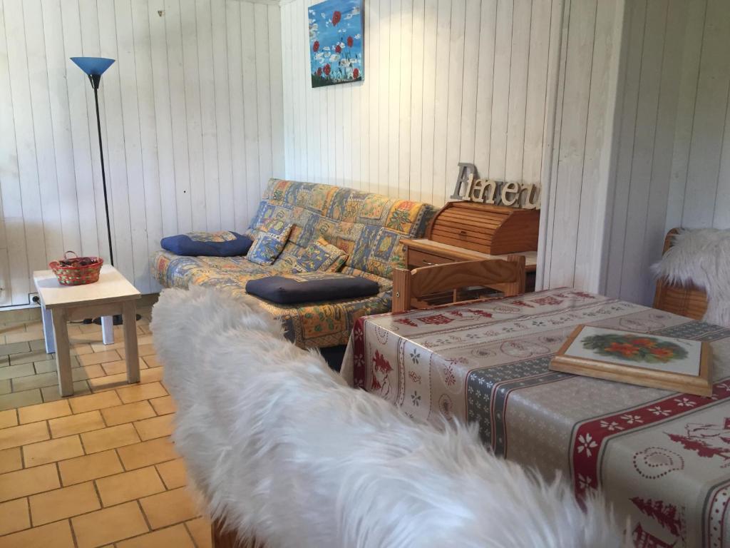 a living room with a couch and a table at La Tannerie in Le Bourg-dʼOisans