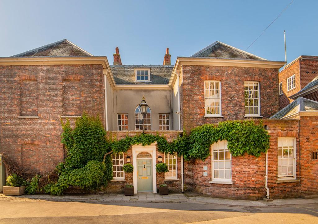 a large brick house with a white door at Pelham House in Lewes