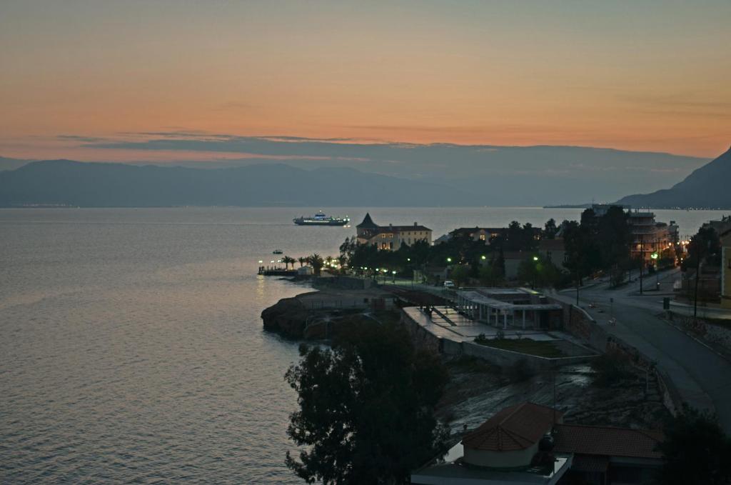 a boat in the water at sunset at Pension Remvi in Loutra Edipsou