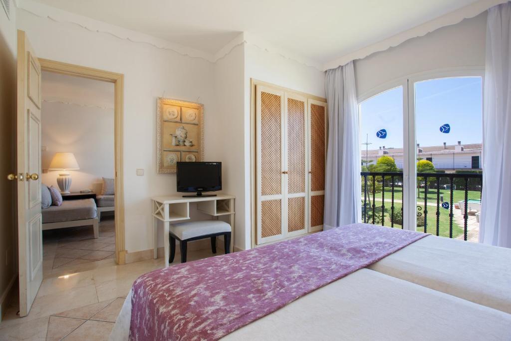 A bed or beds in a room at Grupotel Macarella Suites & Spa