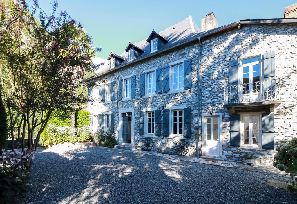 an exterior view of a stone house at Le domaine des 3 marmottes Chambres d' hôtes in Cierp