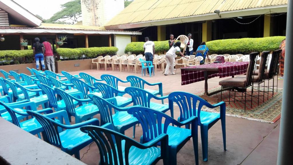 a group of blue chairs sitting on a patio at Mt Moroto Hotel in Moroto