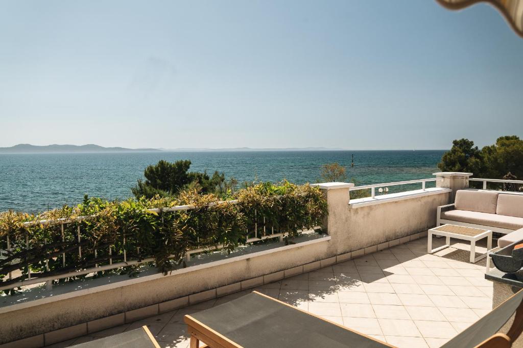 a balcony with a view of the ocean at Apartments Lucija in Zadar