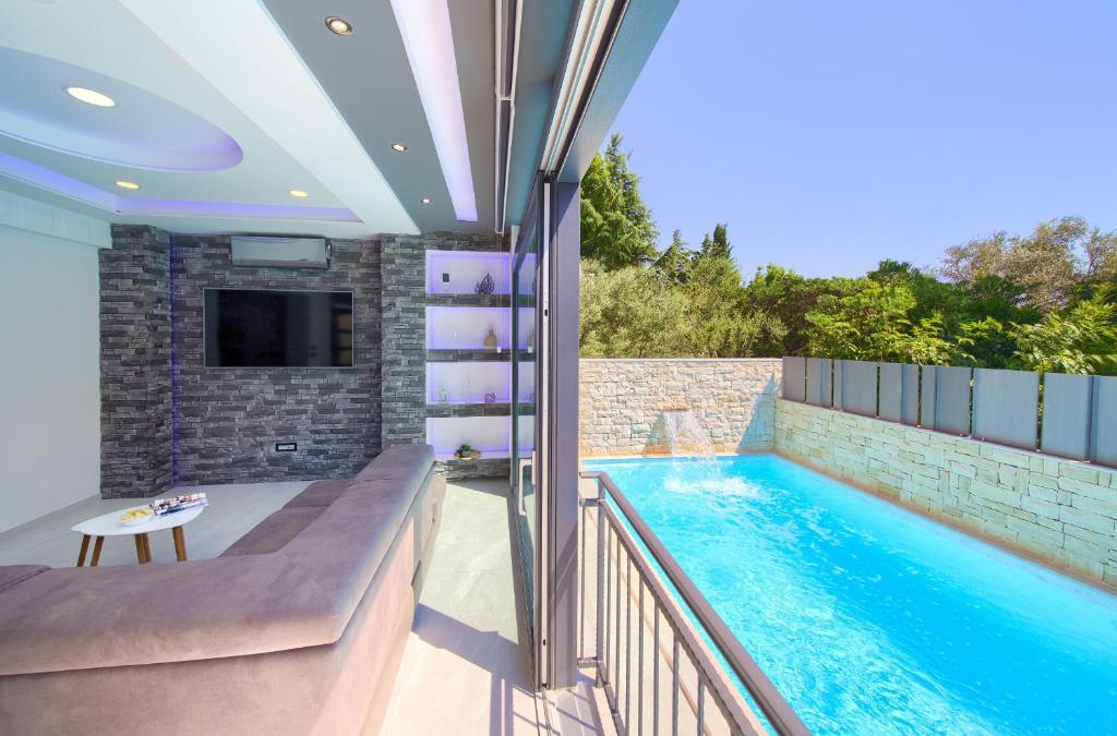 a swimming pool in the middle of a house at Luxury VALL Apartment in Krk