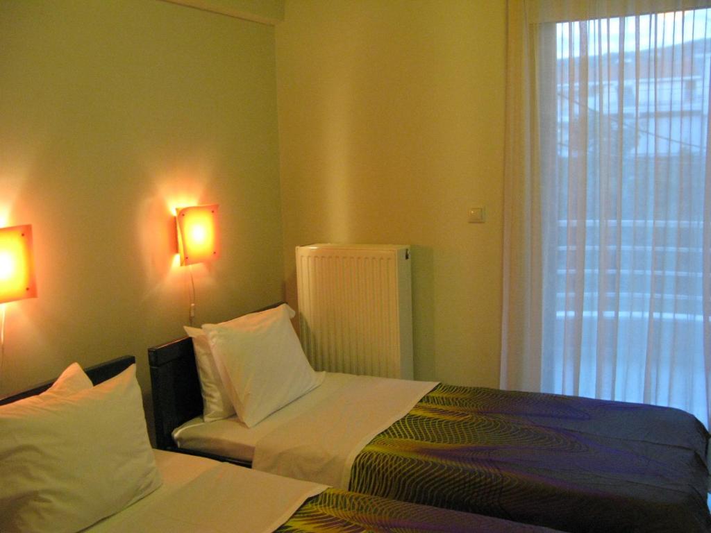 Postel nebo postele na pokoji v ubytování ALEXANDER Rooms