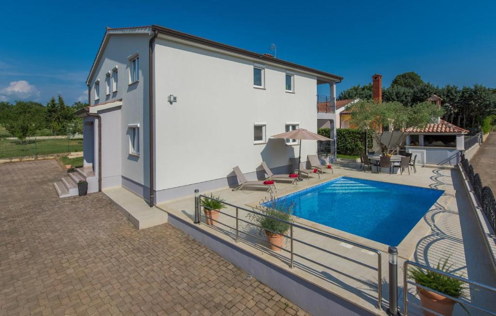 a house with a swimming pool on a balcony at Silver Holiday House in Poreč