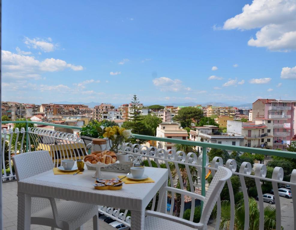 a white table and chairs on a balcony with a view at Relais Bellavista B&B in Casalnuovo di Napoli