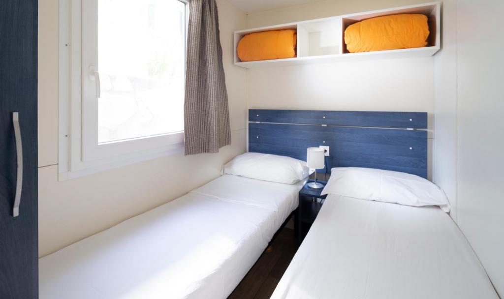 Postel nebo postele na pokoji v ubytování Camping Genova Est