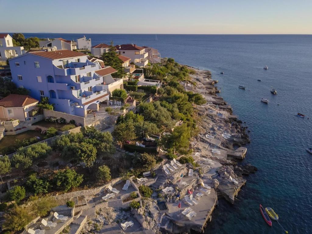 an aerial view of a house on a rocky island in the water at Villa Gorica Apartments Ražanj in Ražanj