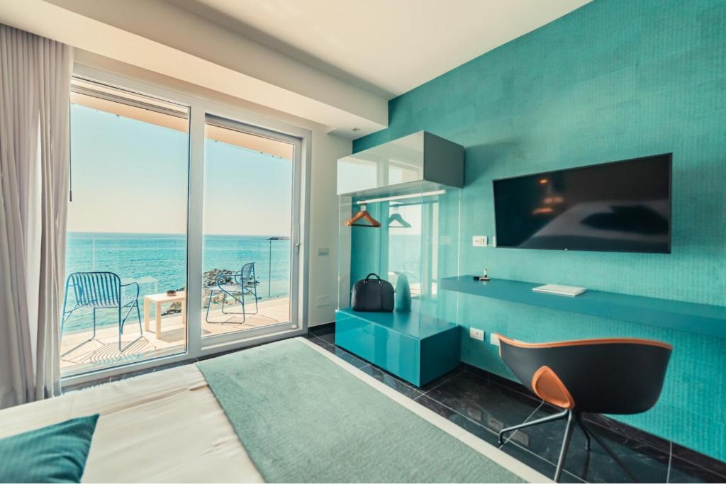 a bedroom with a view of the ocean at Nautilus Hotel in Giardini Naxos
