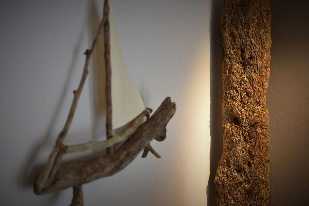 a wooden model of a boat on a wall at Forest 22 in Kavala