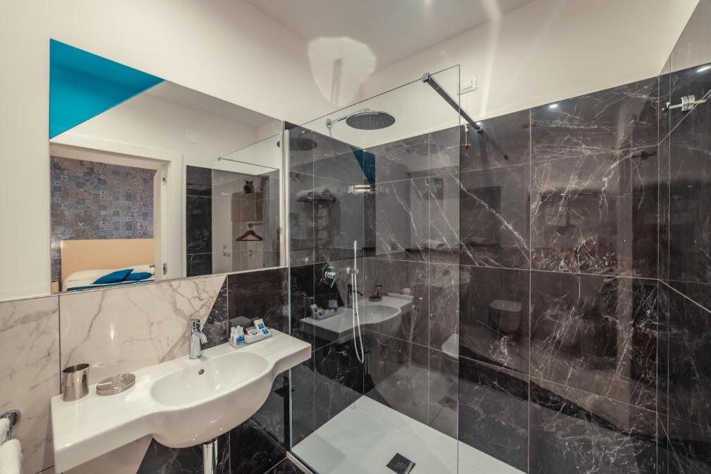 a bathroom with a sink and a mirror at Nautilus Hotel in Giardini Naxos