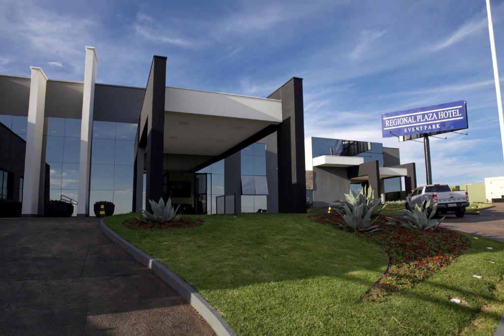 a large building with a sign in front of it at Regional Plaza Hotel Event Park in Jales