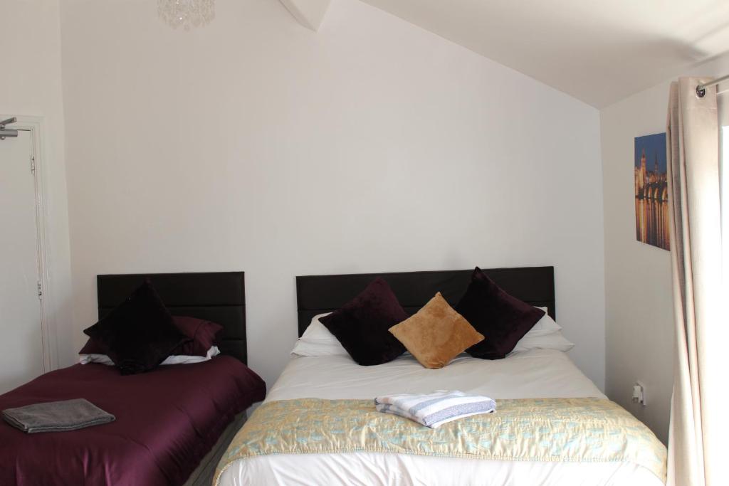 a bed with two pillows on it in a room at Park Lane Heights - Self Catering - Guesthouse Style - Family and Double Rooms in Workington