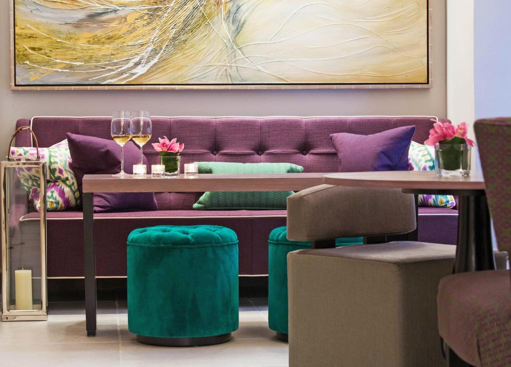 a purple couch with a table and two chairs at Boutique Hotel Stari Grad in Dubrovnik