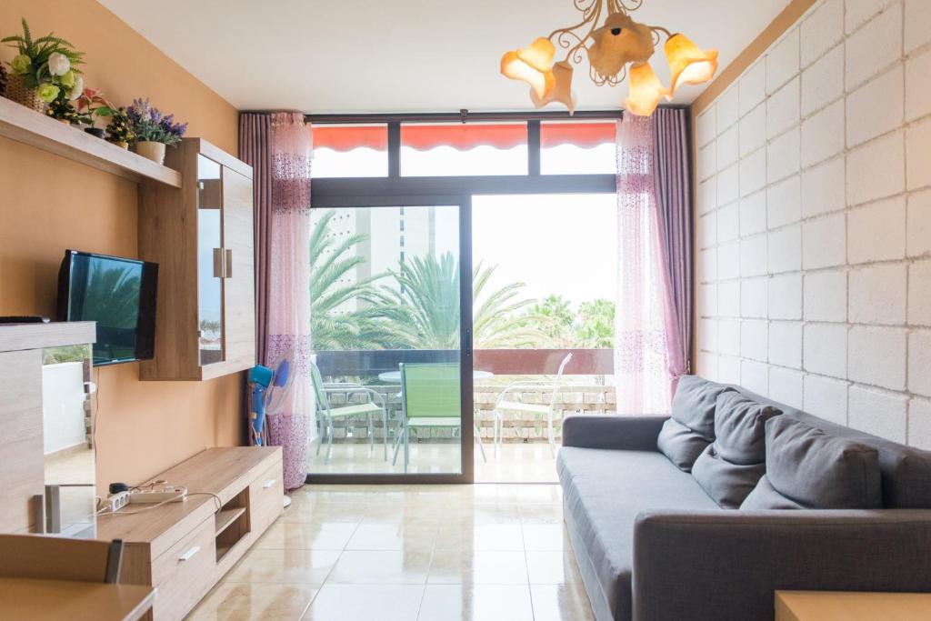 a living room with a couch and a sliding glass door at Las Piteras (1) in Arona