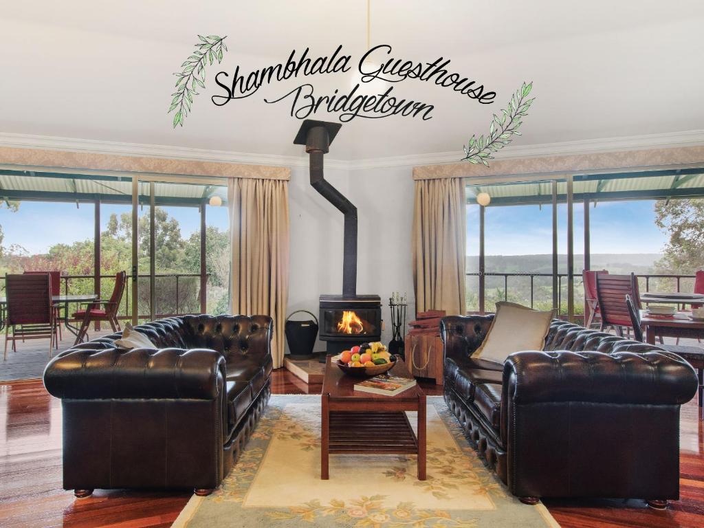 a living room filled with furniture and a fire place at Shambhala Guesthouse in Bridgetown
