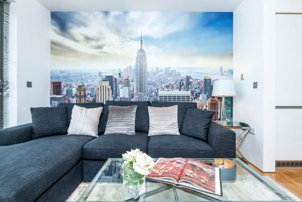 a living room with a couch with a view of the city at Haggerston Studios in London