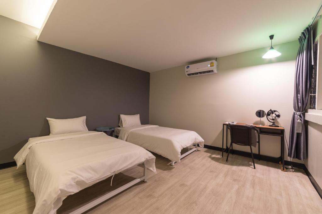 Postel nebo postele na pokoji v ubytování Napa Hostel Samrong Station