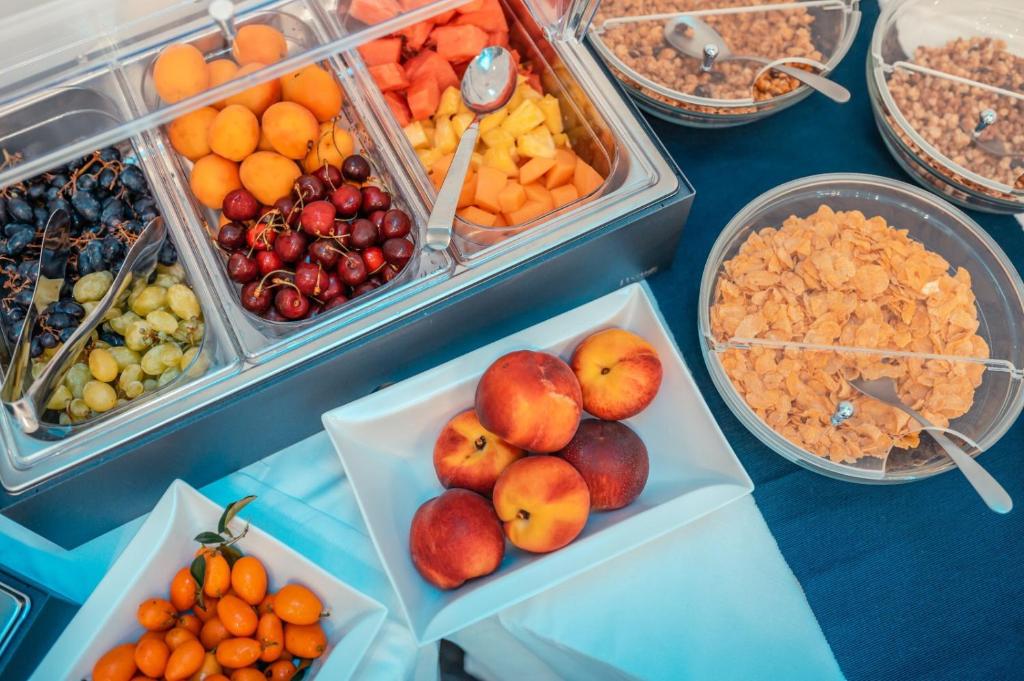 a display of fruits and vegetables in plastic containers at Nautilus Hotel in Giardini Naxos