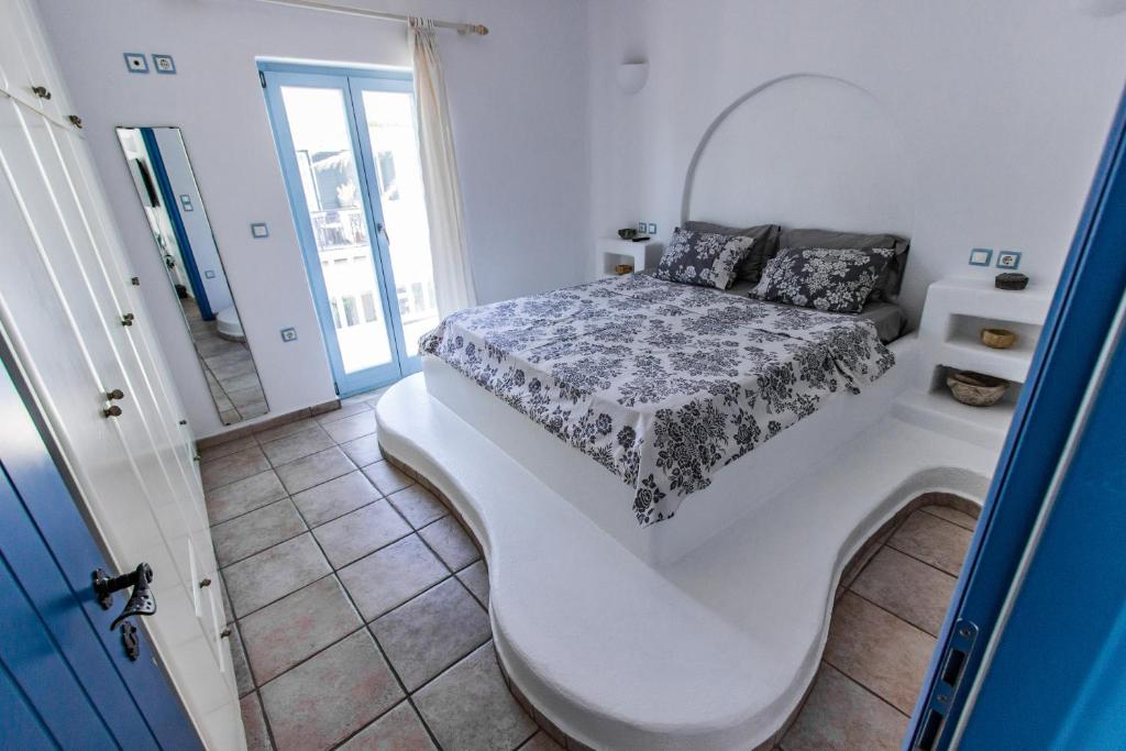 a bedroom with a bed on a white floor at Casa Bianca in Antiparos Town