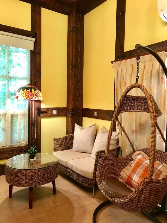 a living room with a couch and a swing at Rothenburg Lodge in Wujie