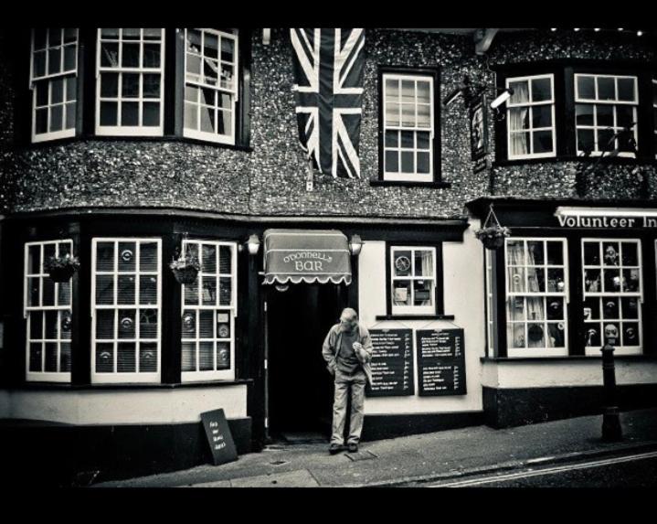 a man standing in front of a building at Room at the Inn in Lyme Regis